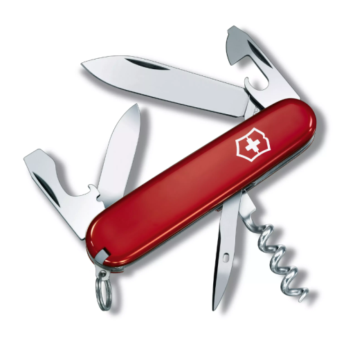 Una navaja suiza roja, etiquetada como Cortapluma Tourist Roja 12 Funciones Victorinox 0.3603, está abierta y muestra varias herramientas, entre ellas una hoja grande, una hoja pequeña, un abrebotellas, un abrelatas, un destornillador y un sacacorchos. La navaja tiene un logotipo de cruz blanca en el mango y un llavero adjunto en el extremo.