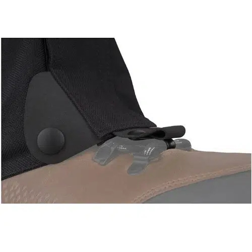 Primer plano de una bota con correa negra y botón a presión en el lateral, con una combinación de colores tostado y gris. Junto a la correa, hay una pestaña de plástico borrosa con forma de perro para agregar detalles. Este estilo combina perfectamente con las polainas Sea To Summit Quagmire Gaiters Canvas (SIN PFC) M Black de Polainas para una protección resistente en todos los terrenos.