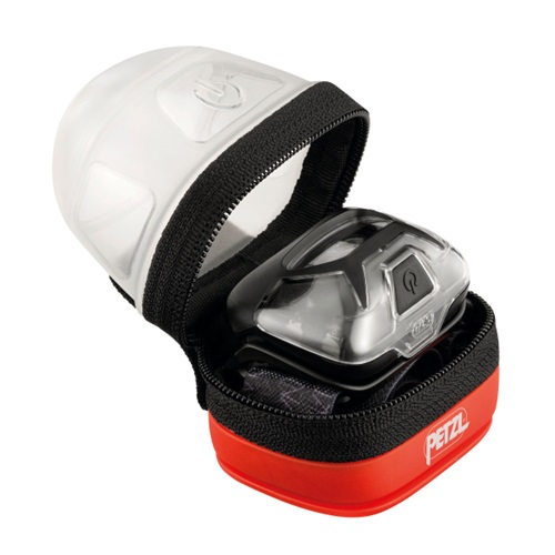 Estuche Difusor para Linterna Frontal Petzl Noctilight, compacto, redondo, de color negro y rojo, abierto, revela una linterna frontal en su interior. La linterna frontal cuenta con una cubierta transparente y redondeada con un pequeño botón de encendido visible en la parte superior. Este estuche de transporte resalta el diseño interior bien pensado incluso cuando está parcialmente abierto.