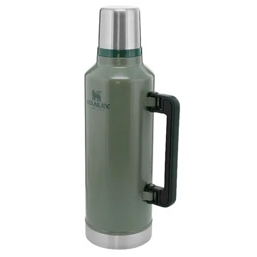 Un termo Stanley Classic grande de color verde de 2,36 L con tapa y base plateadas brillantes, un asa negra en el lateral y la marca "Stanley" impresa en el frente. Diseñado para mantener las bebidas frías o calientes.