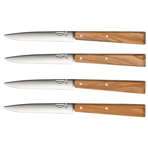 El Set de Cuchillos Opinel N°125 Bon Appetit Olivo 4 piezas incluye cuatro cuchillos de cocina idénticos, cada uno con una elegante hoja de acero inoxidable y un mango minimalista de madera de color marrón claro. Perfectamente dispuestos en filas paralelas, estos cuchillos combinan practicidad y elegancia.