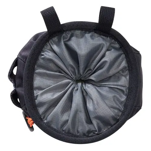 Vista de arriba hacia abajo de una bolsa Petzl para magnesio Sakapoche con un exterior negro y un interior gris con diseño de cuadrícula. Esta bolsa con cordón tiene dos presillas negras en la parte superior para sujetarla.