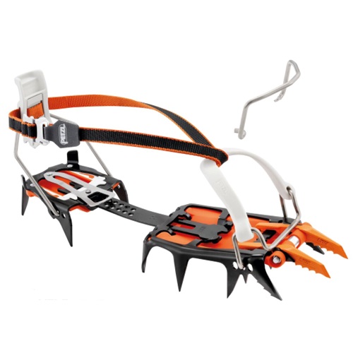 Un par de crampones modulables Petzl Lynx 2024 en color naranja y negro, diseñados para escalada en hielo y montañismo. Estos crampones cuentan con puntas metálicas afiladas, correas ajustables y una palanca en el talón. En el fondo, se puede ver un accesorio metálico suelto.