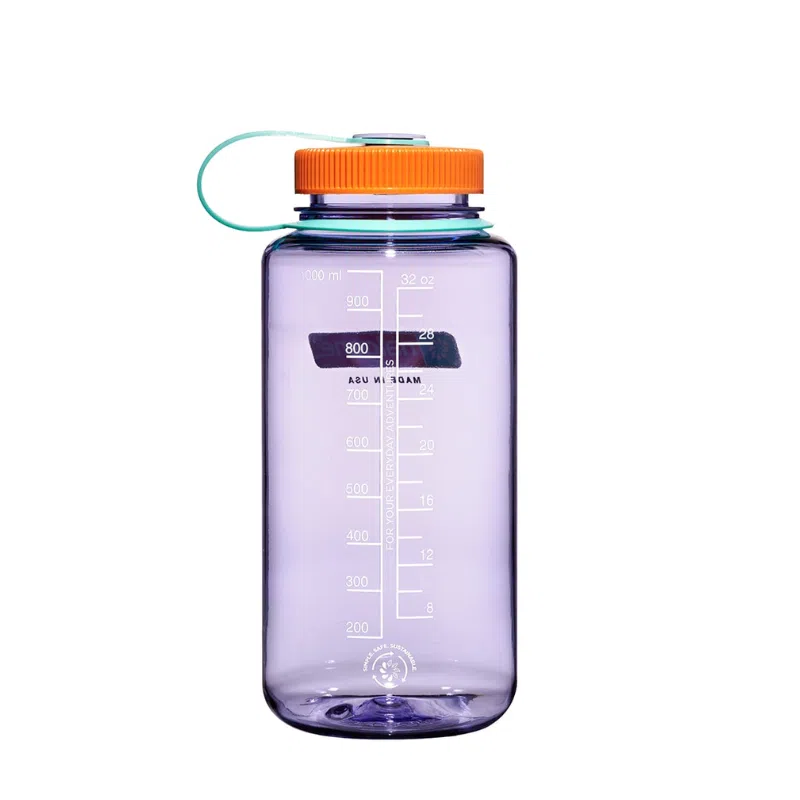 La botella Nalgene Wide Mouth Sustain de 1 l en color morado transparente viene con una tapa de rosca naranja y un asa de transporte de color verde azulado. Incluye marcas de medición de hasta 1000 ml (32 oz), lo que ofrece practicidad y estilo.