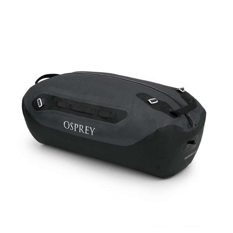 La mochila de lona Osprey Tempest 20 Mujer (copia) se presenta en negro y gris oscuro, haciendo eco de su elegante diseño. Incluye una cremallera superior, dos asas y presenta de manera destacada el nombre de la marca "Osprey" en el costado, todo mientras mantiene una estética compacta.