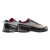 Las zapatillas de senderismo La Sportiva TX4 Mujer en gris y negro con detalles en rosa y verde azulado presentan suelas resistentes con la marca La Sportiva, mostradas una al lado de la otra para resaltar su diseño único.