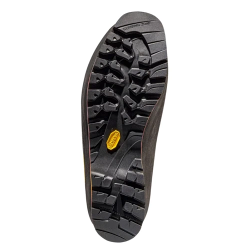 La bota de montaña La Sportiva Karakorum Evo GTX (copia) presenta una banda de rodadura profunda para un agarre y tracción superiores, con un logotipo amarillo en el centro y tacos angulares y audaces, lo que la hace perfecta para aventuras de senderismo.