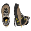 Las botas de senderismo La Sportiva TX5 GTX para mujer presentan un diseño marrón y negro con detalles en amarillo, cierre con cordones y la marca "La Sportiva". Una de las botas se muestra desde arriba, mientras que la otra muestra su perfil lateral.