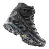 La zapatilla de trekking La Sportiva Ultra Raptor II Mid GTX es una bota de senderismo de caña alta en color negro y gris con banda de rodadura resistente, diseño texturizado, marca lateral visible y un patrón de agarre impresionante.