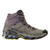 La zapatilla de trekking La Sportiva Ultra Raptor II Mid Leather GTX, en color gris y amarillo, tiene un cuello alto en el tobillo, un logotipo "La Sportiva" azul, una suela resistente con detalles en amarillo y ojales de metal para cordones.