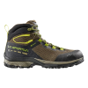 La bota La Sportiva TX Hike Mid GTX presenta una suela resistente, una combinación de colores marrón y negro con detalles y cordones verdes, un diseño de tobillo alto, una parte superior de malla transpirable y una marca lateral prominente, ideal para actividades al aire libre.