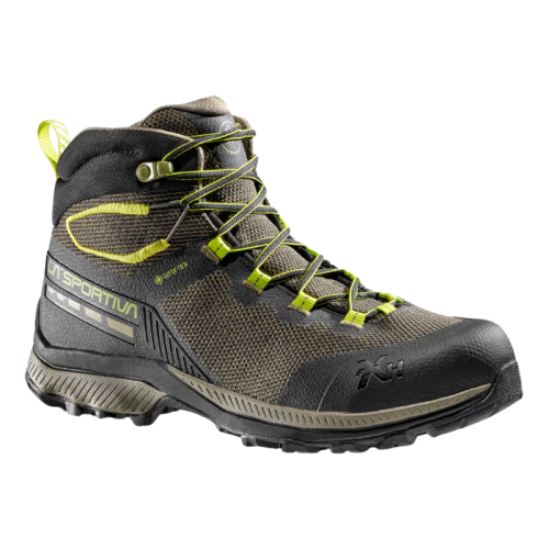 La bota de trekking La Sportiva TX Hike Mid GTX es una zapatilla de senderismo de caña alta en marrón y negro con detalles y cordones verdes, que presenta una suela resistente para tracción y una marca lateral sutil.