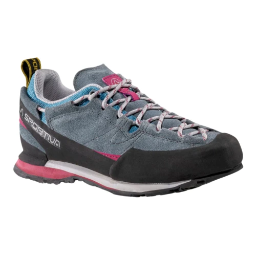 La zapatilla de aproximación La Sportiva Boulder X Mujer viene en gris y rosa con cordones multicolor, suela de goma duradera y puntera negra. El nombre de la marca se muestra de forma destacada en el lateral.