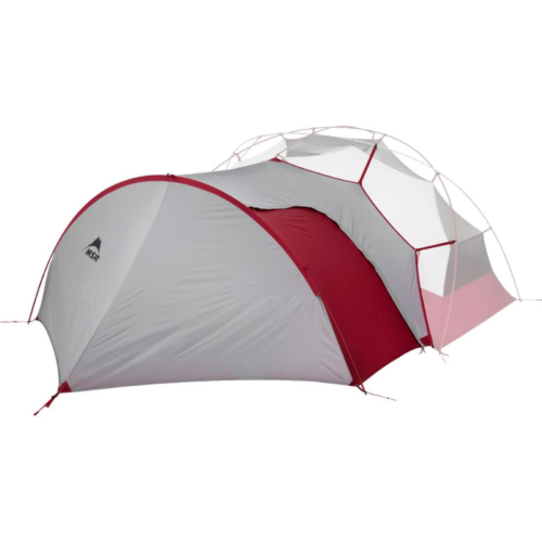 El Carpa MSR Remote 2 (copia), en gris claro y rojo, presenta un diseño geométrico único con una entrada redondeada. El fondo blanco liso resalta de manera efectiva su estructura y combinación de colores.