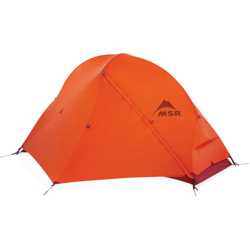 La Carpa MSR Access 1 es una carpa tipo domo de color naranja sobre un fondo blanco, que cuenta con una solapa de entrada frontal y múltiples estacas de estabilidad, con el logotipo de la marca destacado en el costado.