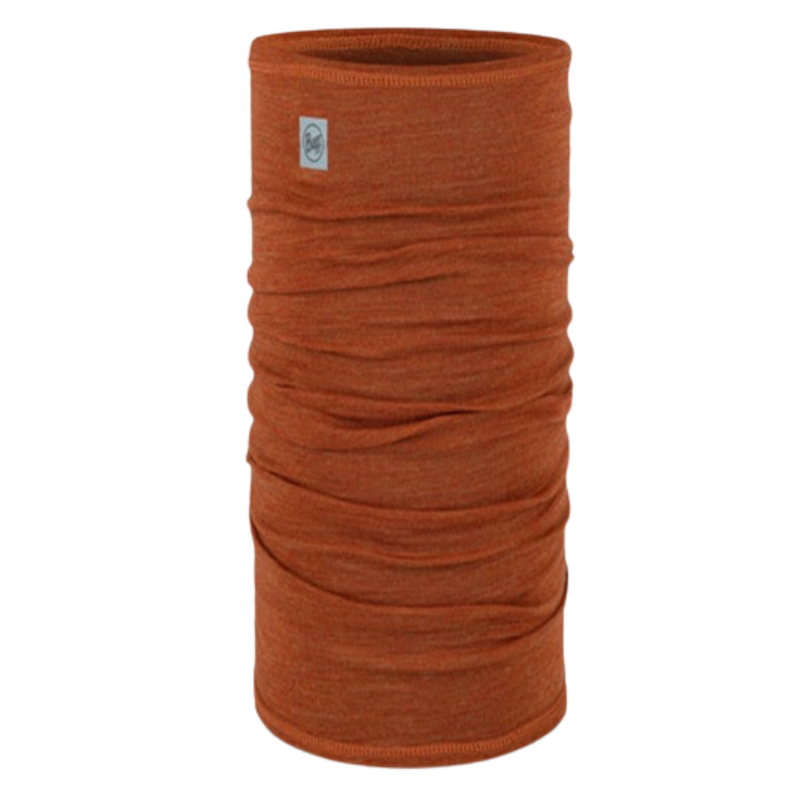 La Bandana Buff Merino Lightweight Multistripes Maize es una polaina para el cuello cilíndrica de color naranja hecha de tela suave y fruncida. Se mantiene en posición vertical y tiene una pequeña etiqueta con el logotipo cerca del borde superior, lo que refleja su versatilidad y ligereza.