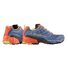 La zapatilla de montaña para correr La Sportiva Prodigio para mujer (copia) presenta un cuerpo de malla azul vibrante con detalles en naranja y amarillo. Las suelas negras duraderas mejoran la estabilidad y el nombre de la marca se muestra de manera destacada en el costado.