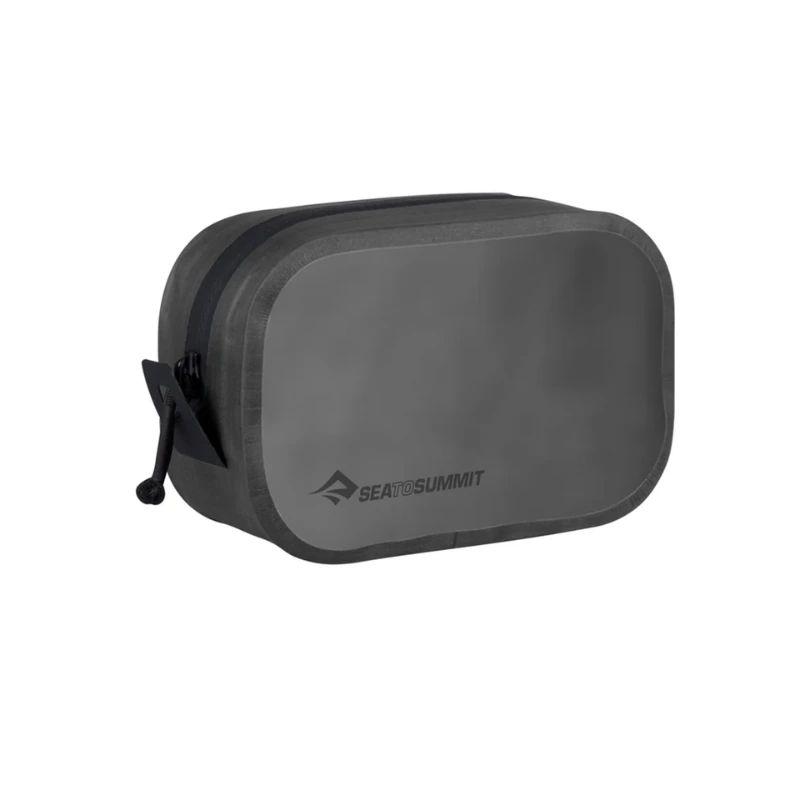 El Cubo de Empaque Hidráulico Sea To Summit es un neceser gris rectangular con bordes redondeados, cierre de cremallera y tirador. Su diseño elegante y minimalista lo hace perfecto para cualquier neceser de viaje.